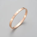 Clover Rhinestone Bangle – Rose gold bracelet with diamond accents on a light surface
